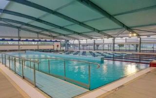 Community swimming pool featuring ARCPANEL insulated roof panels