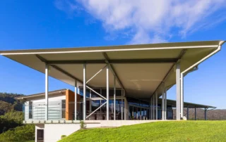Low-pitch insulated roofing with wide overhangs on a modern home