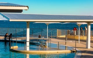 DeltaMax corrosion resistant insulated roofing beside a coastal swimming pool